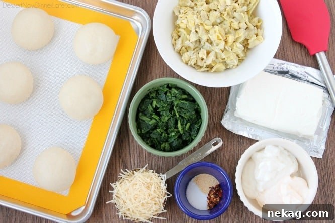 Artichoke Spinach Blossom Bites 5 Ingredients for spinach artichoke cups: Rhodes rolls, frozen spinach, artichoke hearts, cream cheese, shredded parmesan cheese, mayonnaise, sour cream, salt, garlic powder, red pepper flakes.