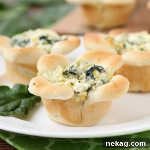 Artichoke Spinach Blossom Bites 10 Creamy Spinach Artichoke Dip is baked in the center of bread cups that are shaped to look like blooming flowers. A fun and delicious Easter appetizer.