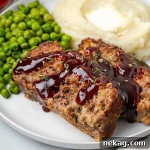 brown sugar meatloaf on white plate with sauce.
