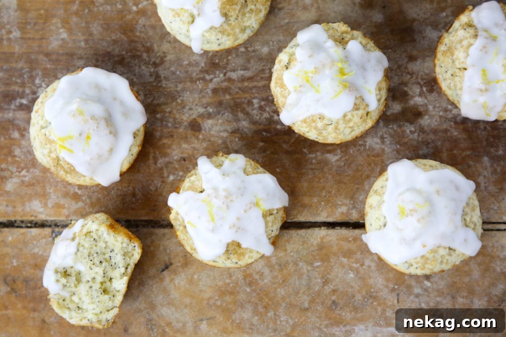 A close-up shot of a single Lemon Poppyseed Muffin, showing the texture of the muffin and the poppy seeds embedded within.