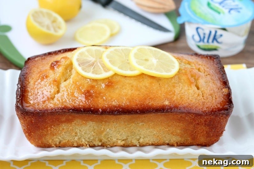 Dairy-Free Sunshine Lemon Yogurt Cake 3 Close-up of a whole dairy-free lemon yogurt cake, ready to be sliced.