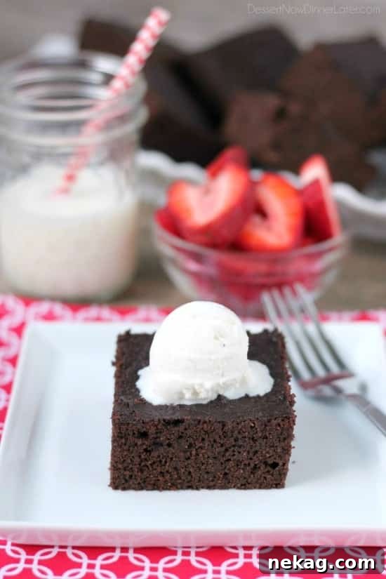 A close-up shot of a single gluten-free coconut flour brownie, highlighting its rich, dark chocolate interior.