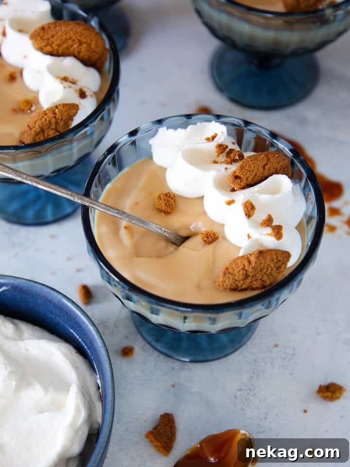 Golden Caramel Delight 2 Caramel pudding served with a silver spoon, emphasizing its smooth texture.