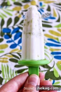 Creamy Coconut Key Lime Popsicles 3 Three Coconut Key Lime Popsicles neatly arranged, highlighting their smooth texture and a hint of lime zest.
