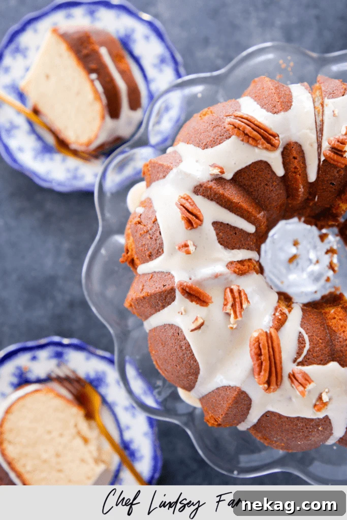 Golden Maple Glazed Pound Cake 6 Beautifully glazed Maple Pound Cake on a rustic wooden board, garnished with fresh maple leaves and ready for serving.