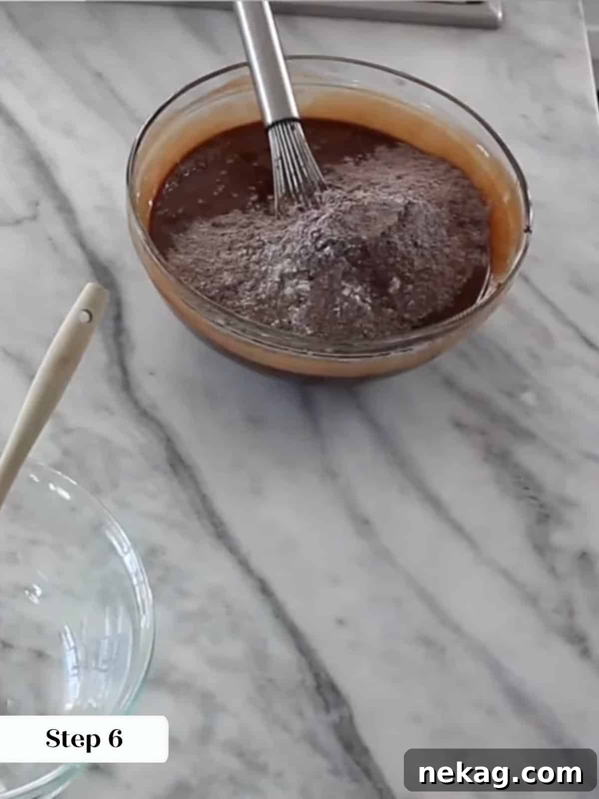 Ultimate Fudgy Brownie Perfection 11 Folding dry ingredients gently into wet brownie mixture to create a smooth, thick batter.