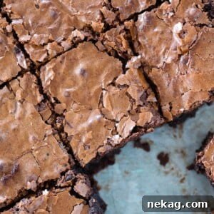 Ultimate Fudgy Brownie Perfection 15 brownies flaky top sliced in pan.