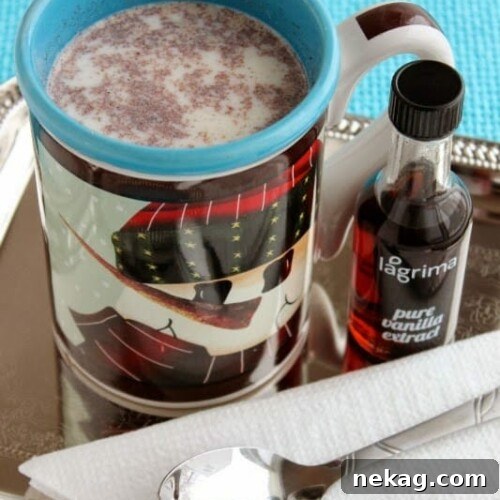Vanilla Spice Steamer served in a glass mug, with a cozy napkin and festive decor.