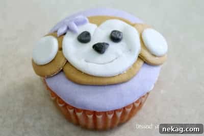 Purple flower, black fondant eyes, and a black fondant nose added to the monkey's face.