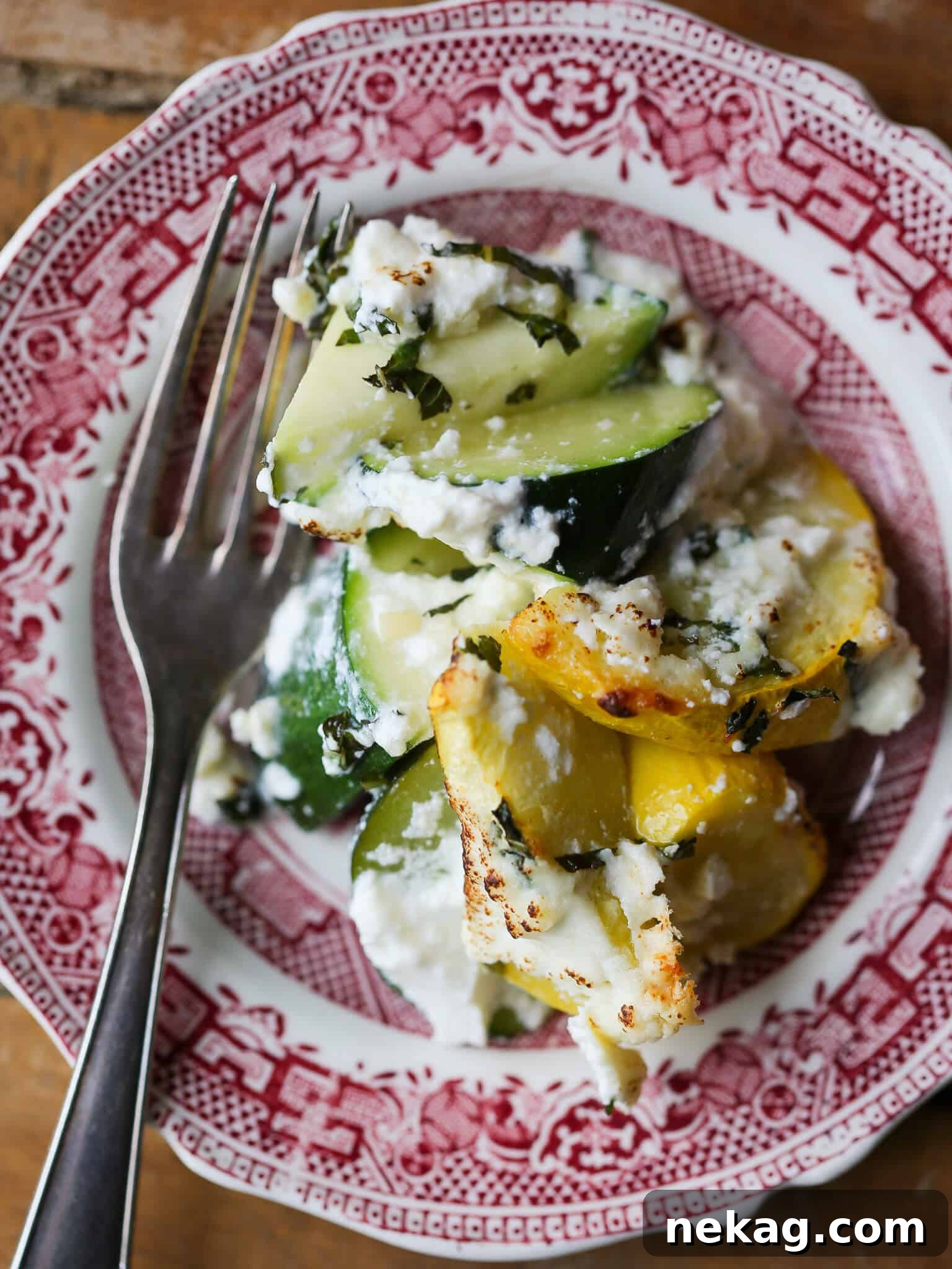 A perfectly portioned slice of Zucchini Ricotta Casserole on an elegant antique plate