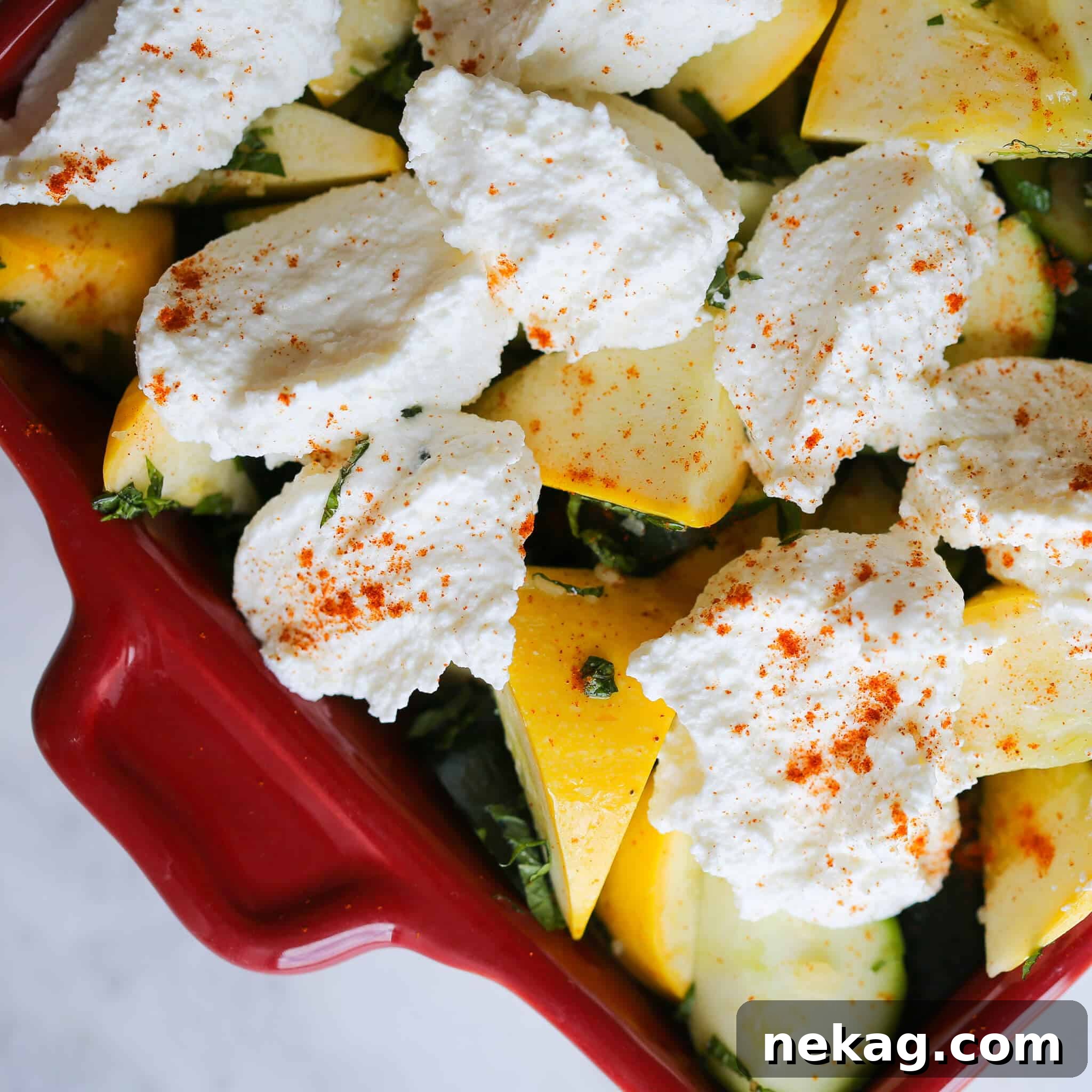 Unbaked Zucchini Ricotta Casserole, showcasing the fresh zucchini and creamy ricotta layers before baking