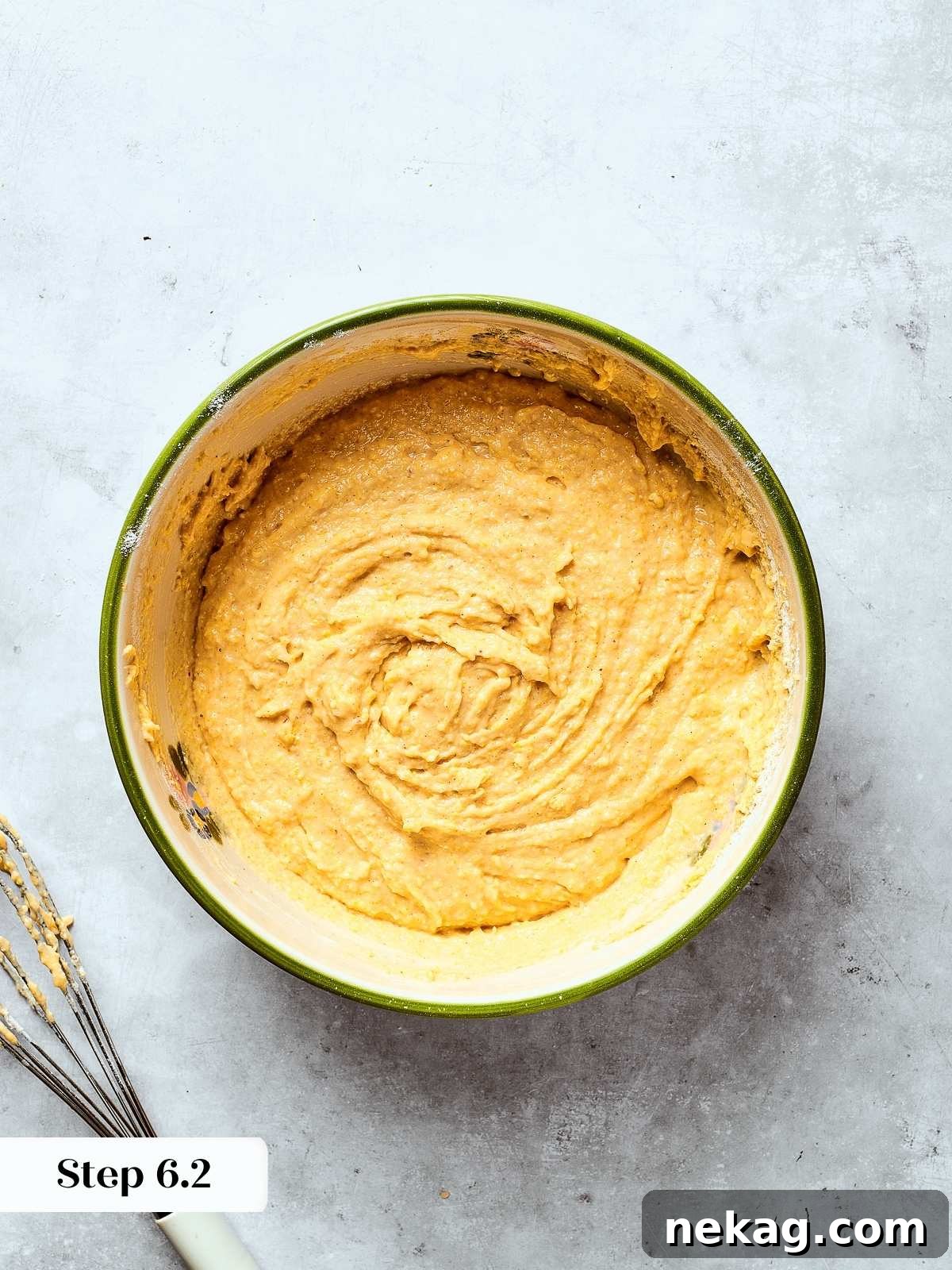 Finished cornbread batter in a mixing bowl showing smooth, creamy texture before baking.
