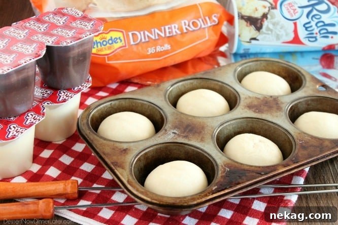 Two Woof 'Ems, campfire eclairs, filled with creamy pudding and topped with whipped cream, ready for enjoyment.