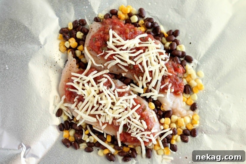 Southwestern Chicken Packets ingredients layered in foil, ready for cooking.