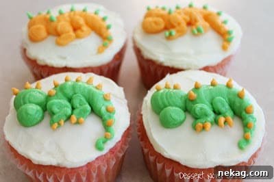 Close-up of a dragon cupcake with eyes, nostrils, and tongue piped.