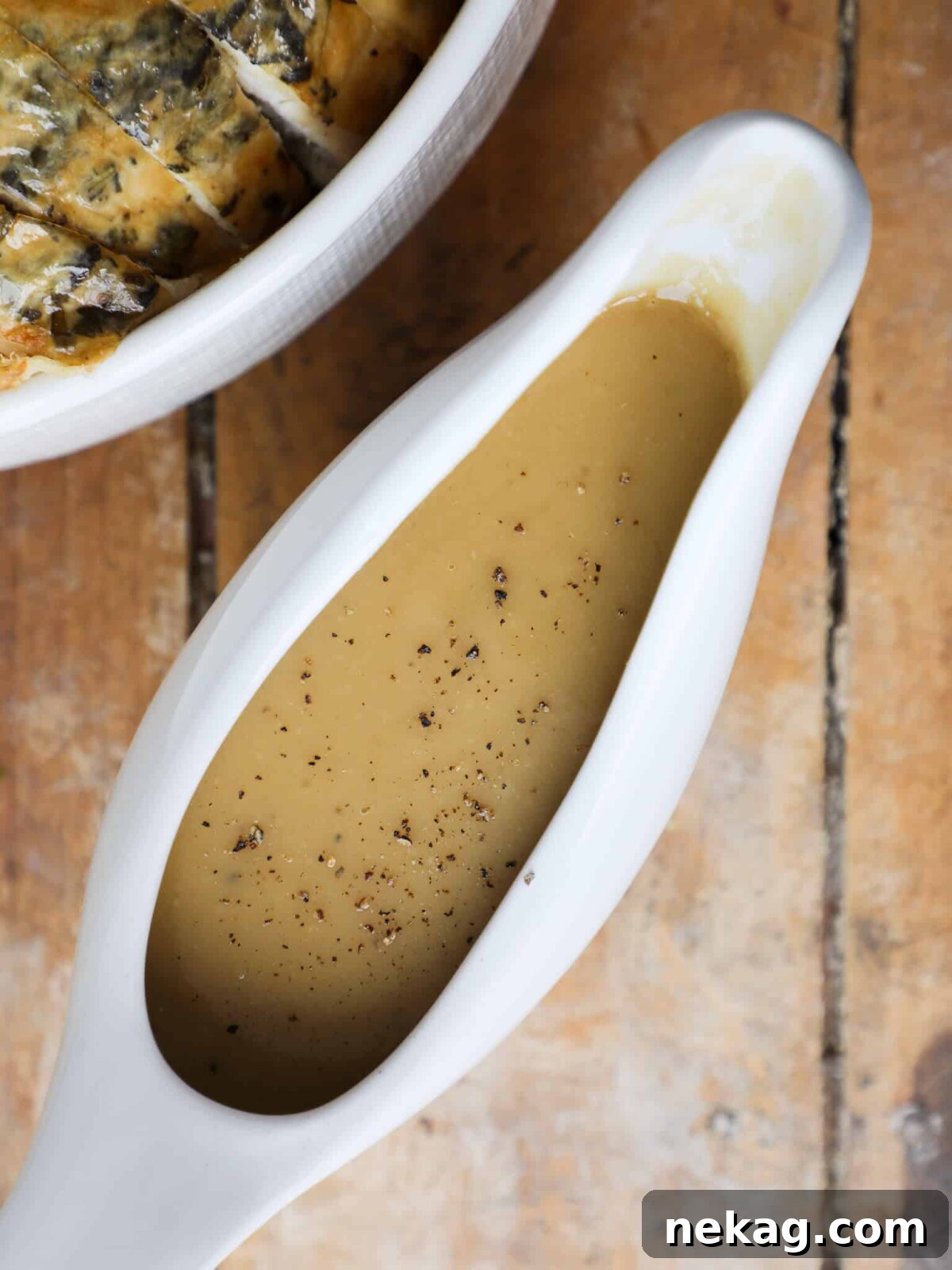 Thanksgiving Traditions A Recipe and Menu Collection 12 Homemade gravy, served from scratch in a white gravy dish, is an indispensable and delicious part of a traditional Thanksgiving dinner.