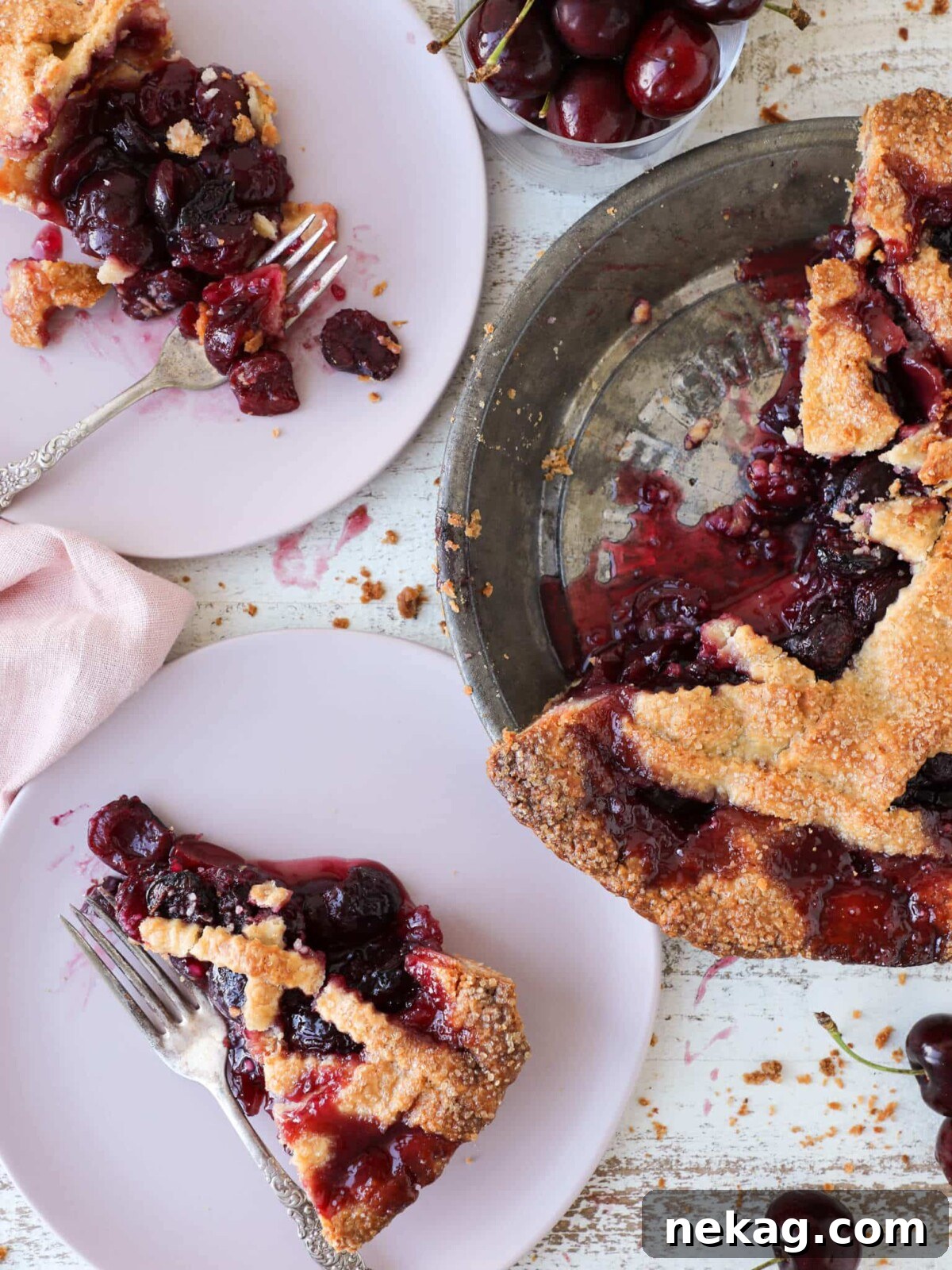 Thanksgiving Traditions A Recipe and Menu Collection 16 A slice of classic cherry pie, beautifully presented in a vintage pie tin, ready for a traditional Thanksgiving dinner.