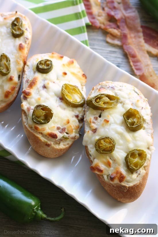 Close-up of a single slice of Jalapeno Popper Bread, showcasing the creamy topping, bacon bits, and melted cheese, ready for a bite.