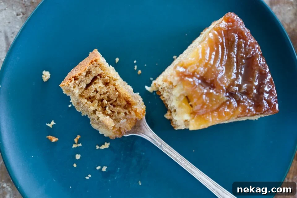 Golden Pear Flip Cake 4 A perfectly sliced Pear Upside Down Cake on a blue plate, showing the layers.