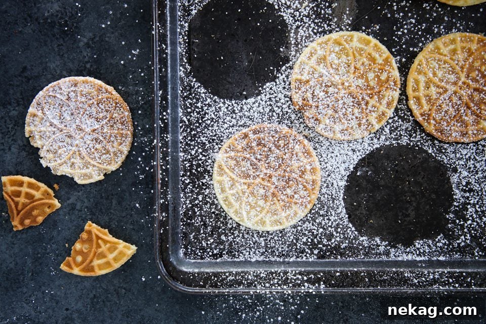 A stack of thin Italian Pizzelle cookies, showcasing their delicate texture and intricate patterns.