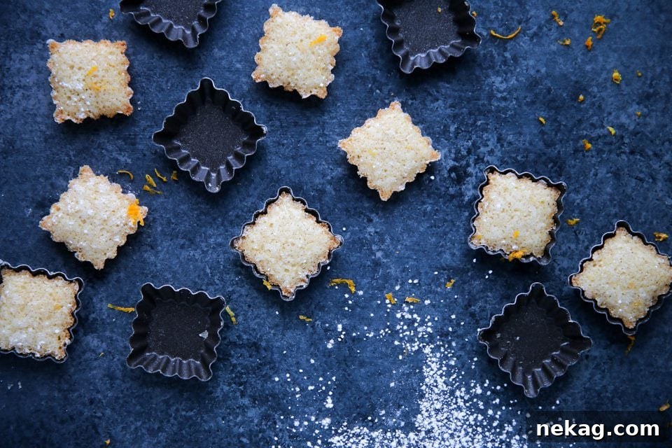 Several Orange Financiers cooling on a wire rack