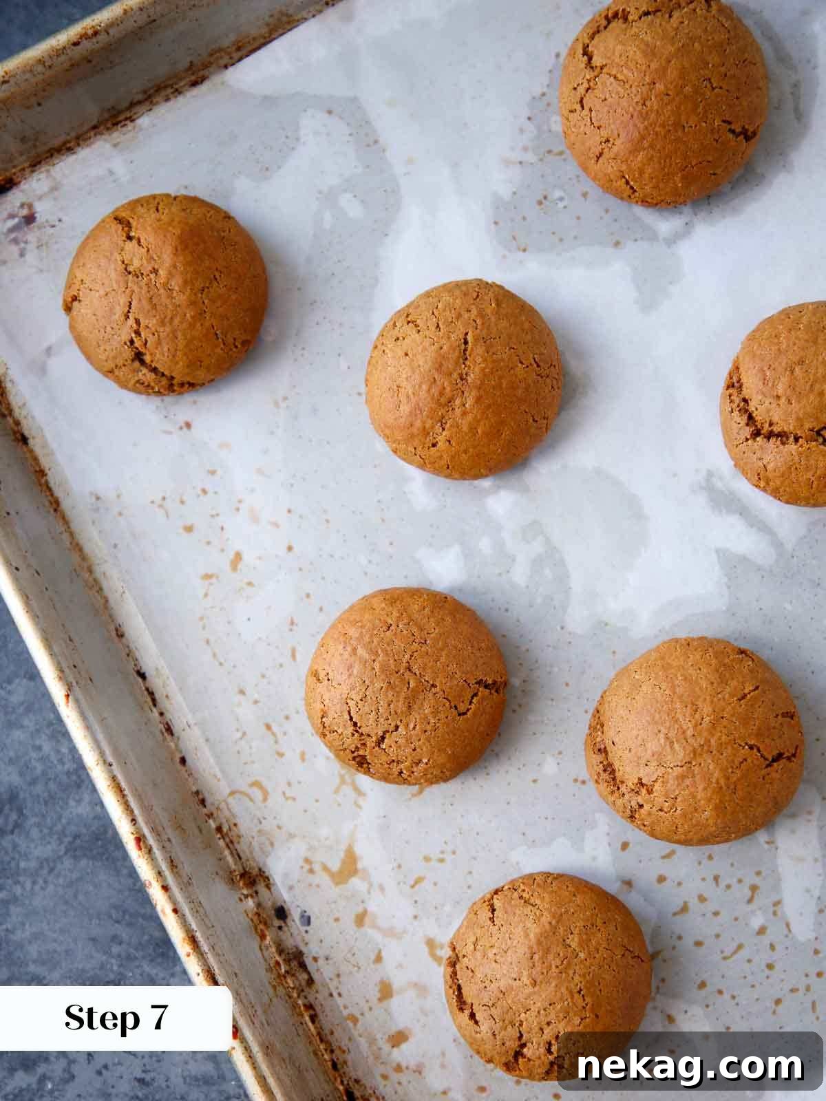 German Christmas Spice Cookies 9 Baked Pfeffernusse cooling on a baking sheet.