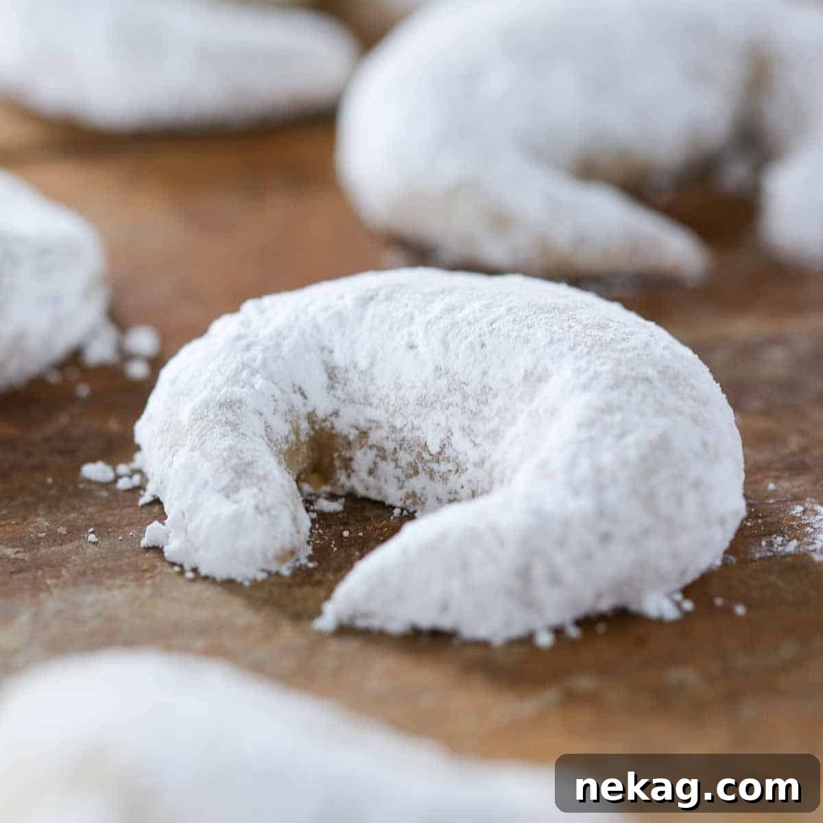 Buttery Almond Crescents 2 powdered sugar coated crescent cookie.