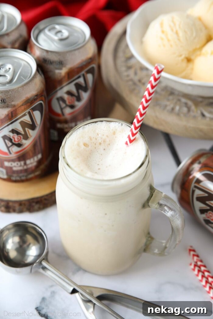 Creamy Root Beer Chill 2 A frosty mason jar mug brimming with a creamy Root Beer Freeze, garnished with a straw, ready to be enjoyed as a perfect summer refreshment.