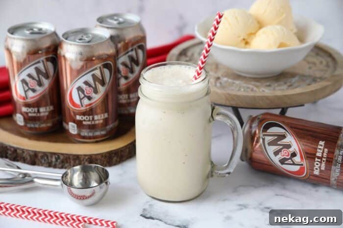 Creamy Root Beer Chill 6 A beautifully presented Root Beer Freeze in a mason jar mug with a straw, capturing its frothy and inviting texture.