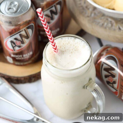Creamy Root Beer Chill 7 Mason jar mug full of root beer milkshake and a straw.