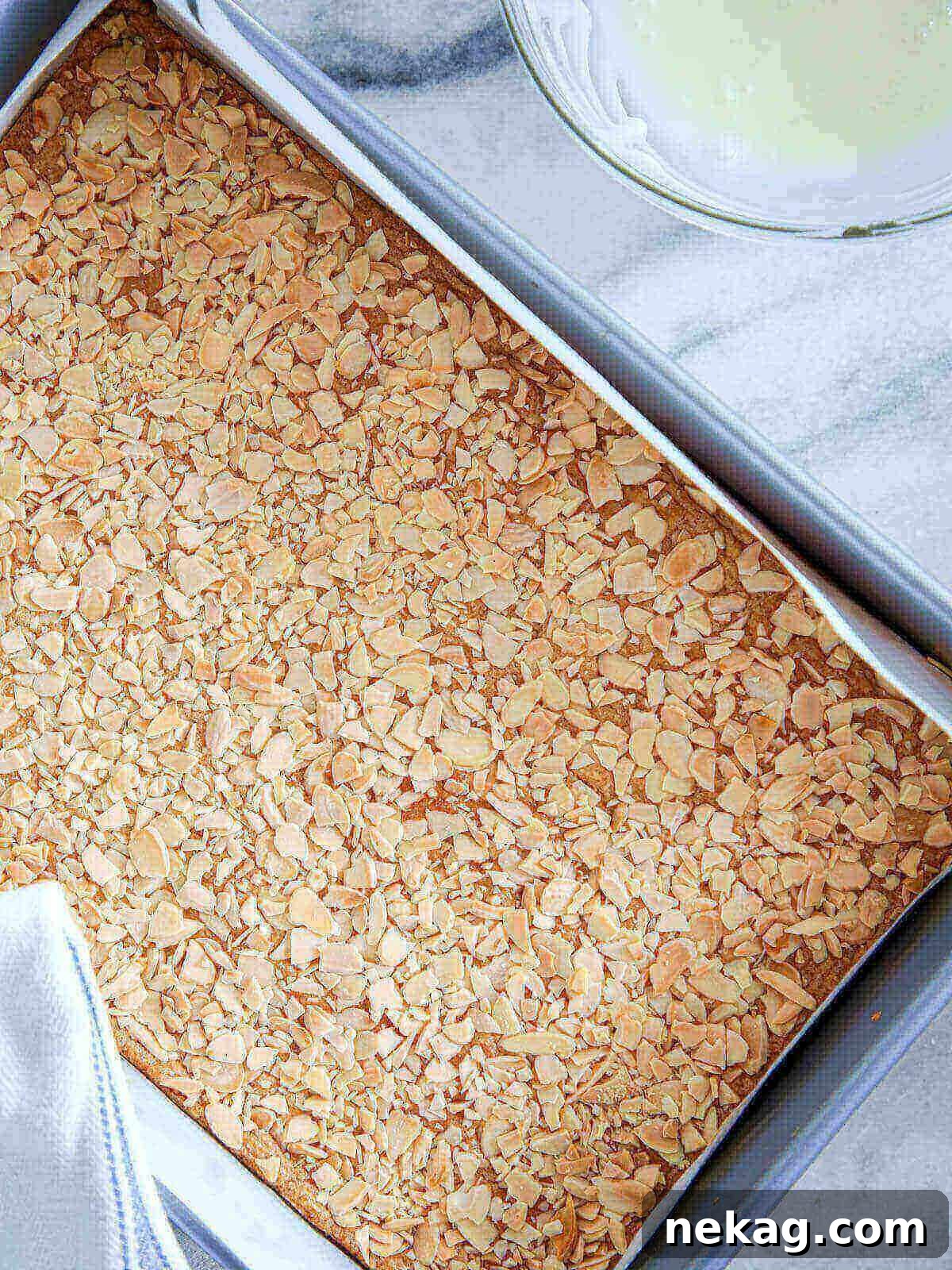 Irresistible Almond Bars 6 Baked cookies in bar form with a golden-brown, crispy almond topping, fresh out of the oven.