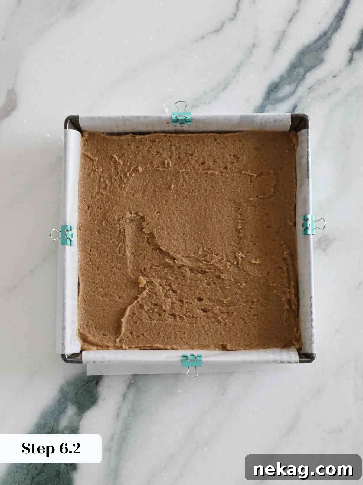 Blondie batter smoothed out in a pan, ready for baking.