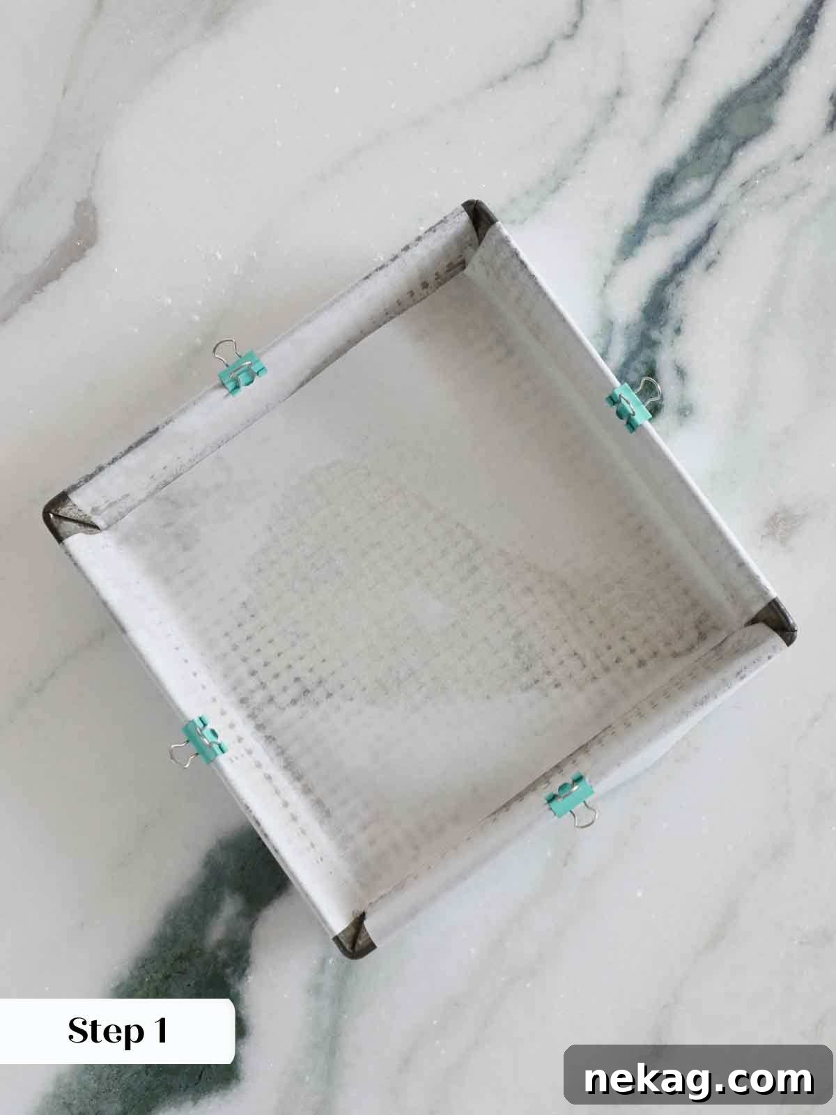 8x8 inch baking pan prepared with parchment paper and binder clips.