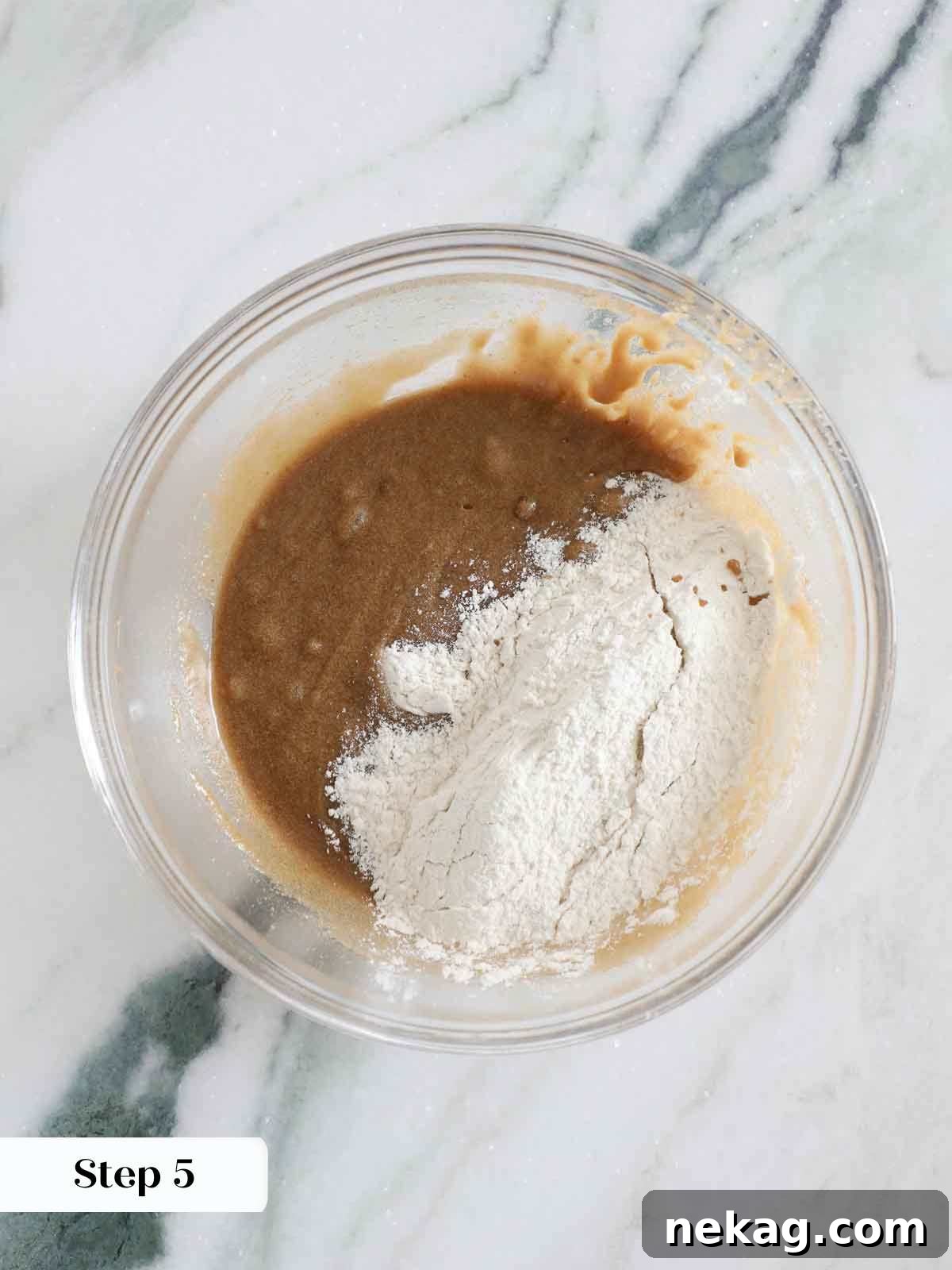 Adding dry ingredients to the wet butterscotch brownie batter.