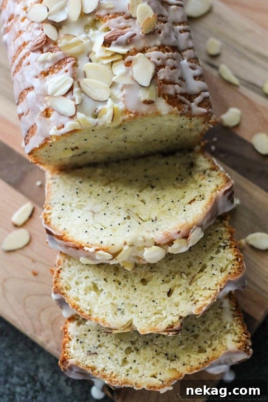 Golden Almond Poppy Seed Loaf 5 Two loaves of freshly baked Almond Poppy Seed Bread, one with a delicate glaze and sliced almonds, inviting to be savored.
