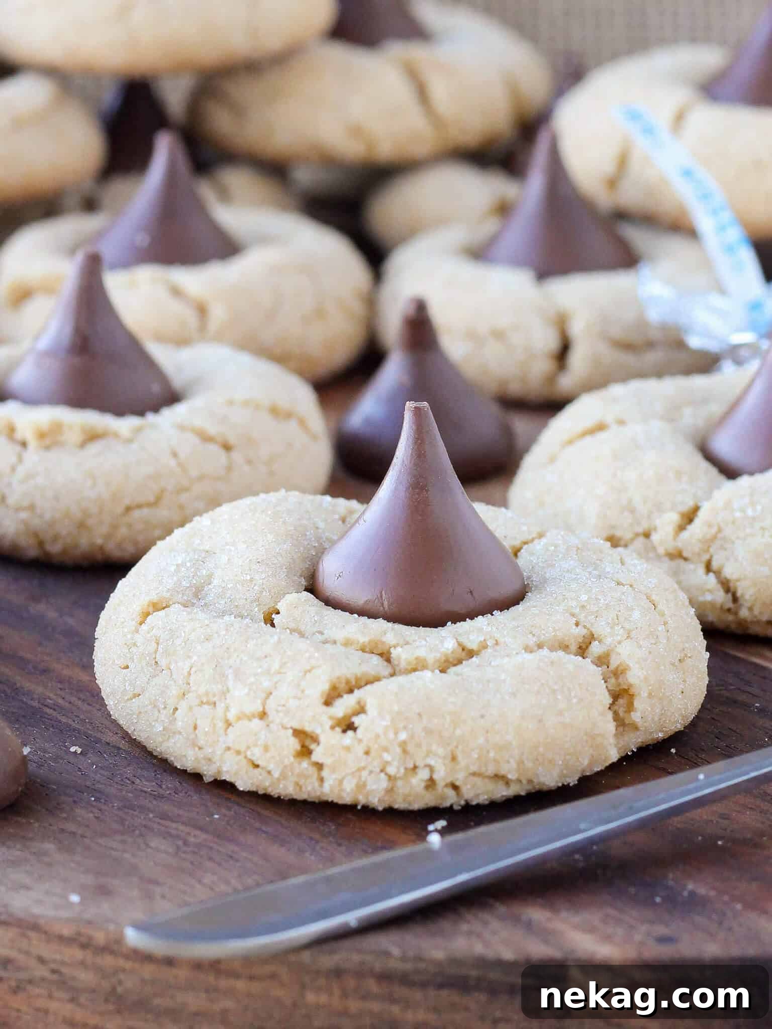 Freshly baked Peanut Butter Blossoms, traditional Christmas cookies topped with Hershey's Kisses.