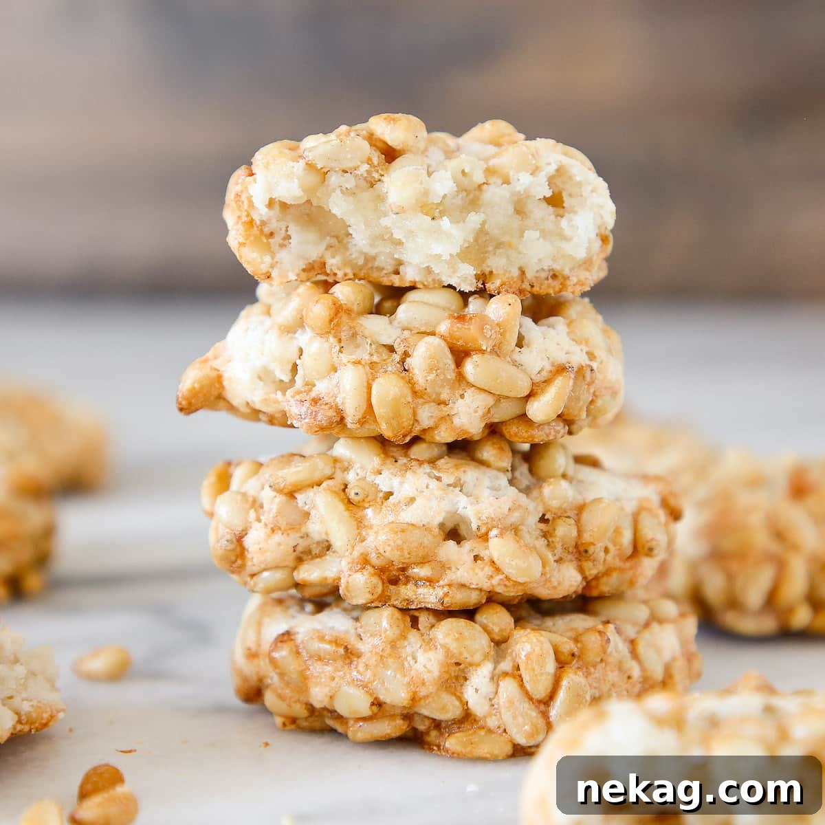 Pignoli Cookies stacked, showing interior detail and the crunchy pine nut exterior.