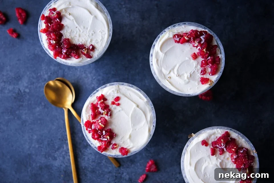 Elegant individual servings of White Chocolate Raspberry Mousse topped with fresh berries.