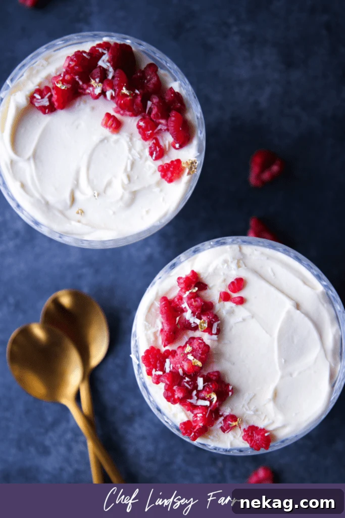 A close-up of White Chocolate Raspberry Mousse in a glass, showing the creamy texture and berry swirl.