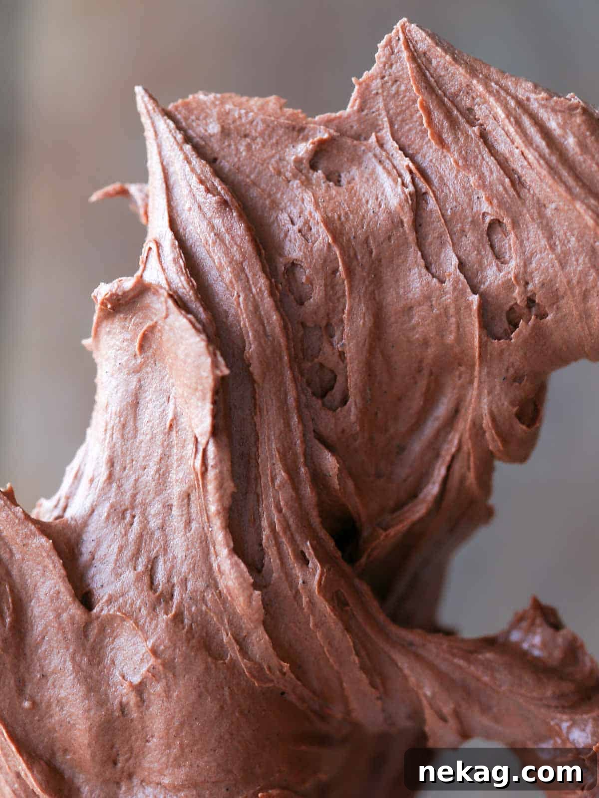 Decadent Chocolate Frosting 2 Swirls of rich chocolate buttercream on a paddle, showcasing its smooth and creamy texture.