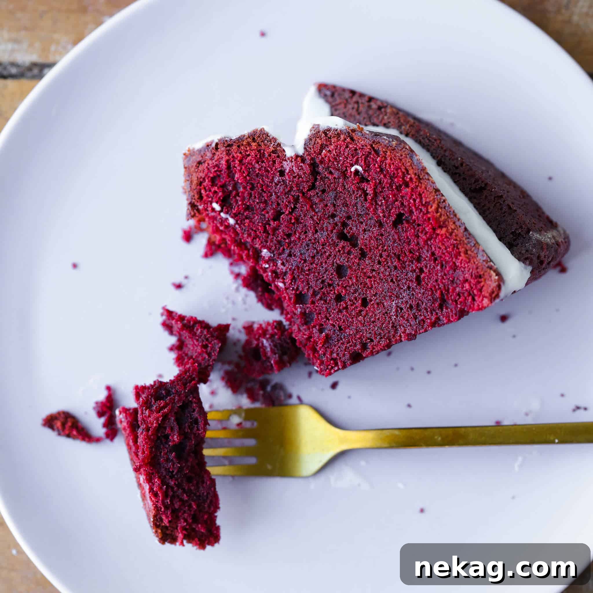 Velvety Crimson Pound Cake 4 Red Velvet Pound Cake Cream Cheese Glaze slice on plate.