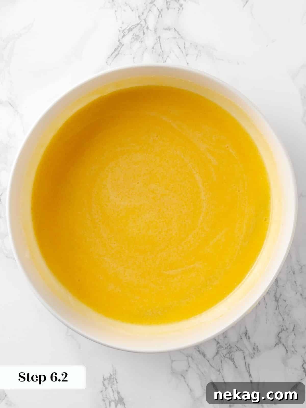 A perfectly smooth, glossy mixture of wet ingredients, now fully combined and ready for the dry components.