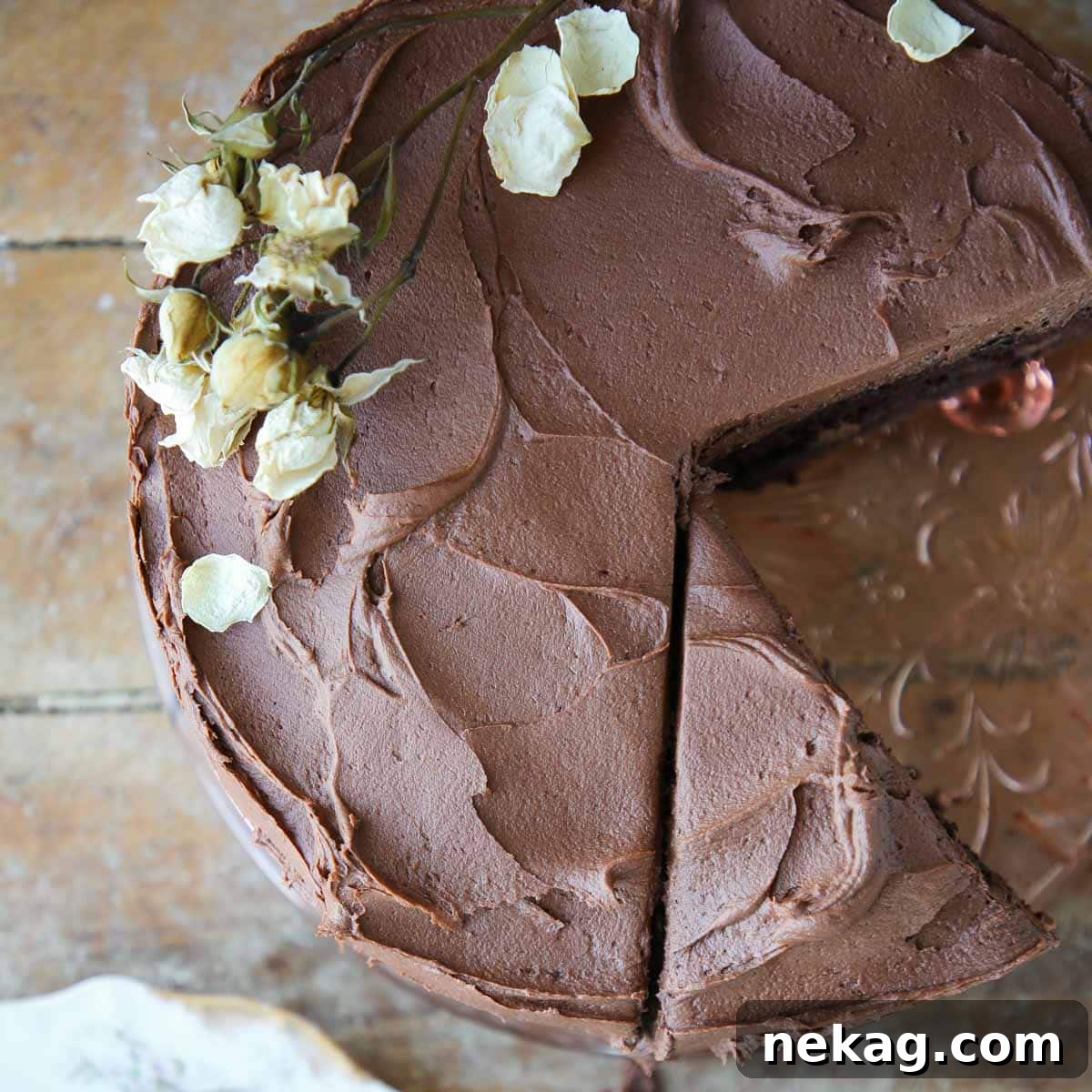 Beautiful swirls of creamy chocolate buttercream frosting expertly applied to a cake, showcasing a smooth and appealing texture.