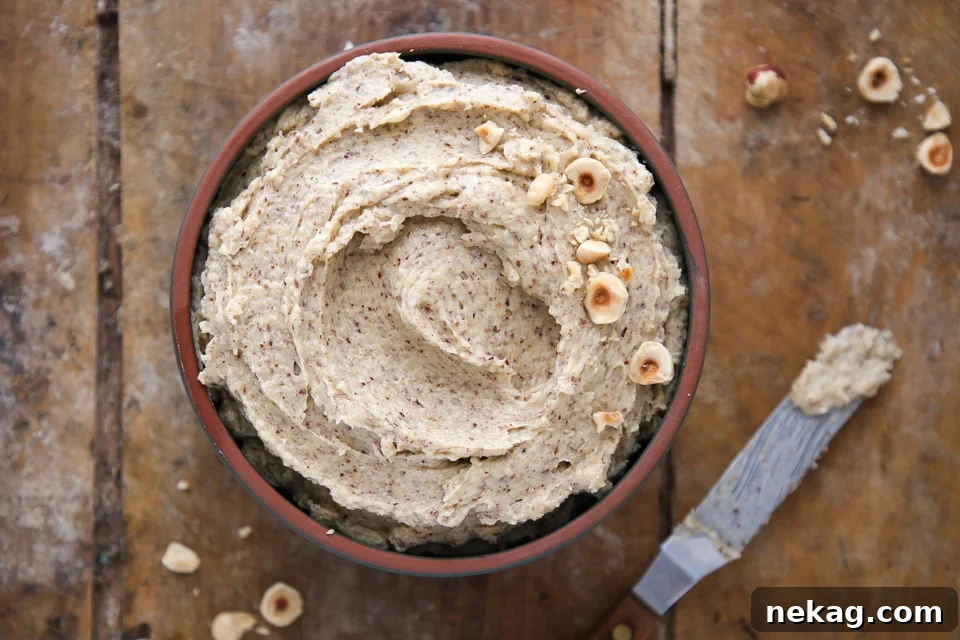 Silken Hazelnut Bliss 5 Hazelnut cream being spread smoothly with an offset spatula, showing its perfect consistency.