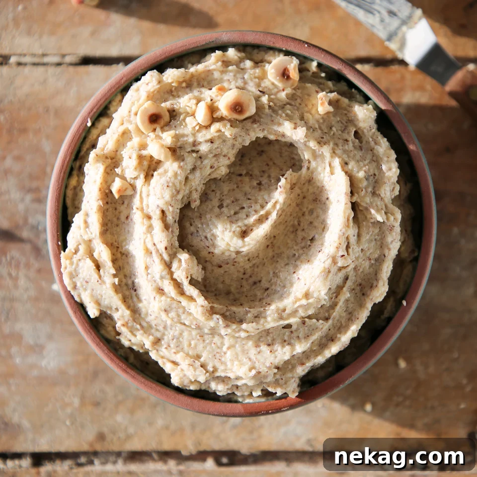 Silken Hazelnut Bliss 6 Hazelnut cream artfully swirled in a bowl, showcasing its smooth texture and readiness for use.
