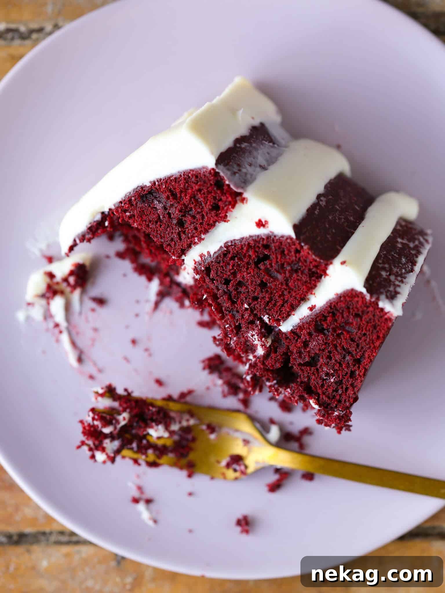 Red Velvet Layer Cake with Cream Cheese Buttercream slice on a plate, a perfect Valentine's Day Dessert.