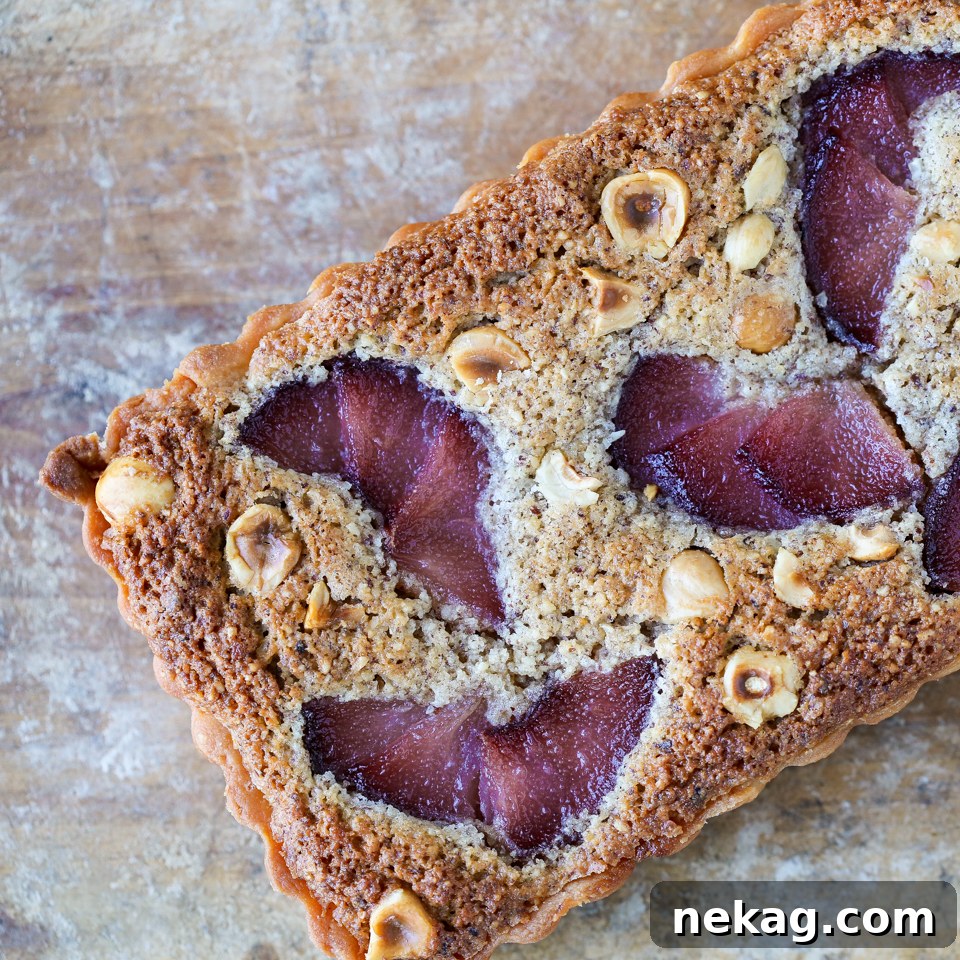 Beautifully baked Hazelnut Pear Tart, golden brown and glistening with pears on top, ready to be served.