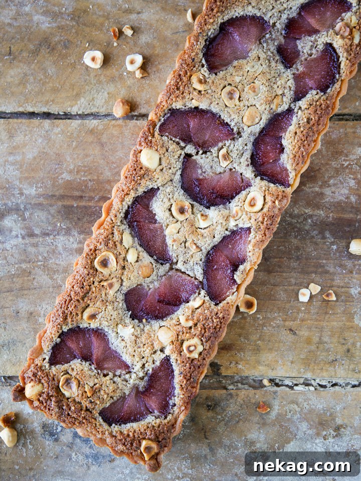 Close-up of a rustic Hazelnut Pear Tart, showing the rich filling and tender poached pears.