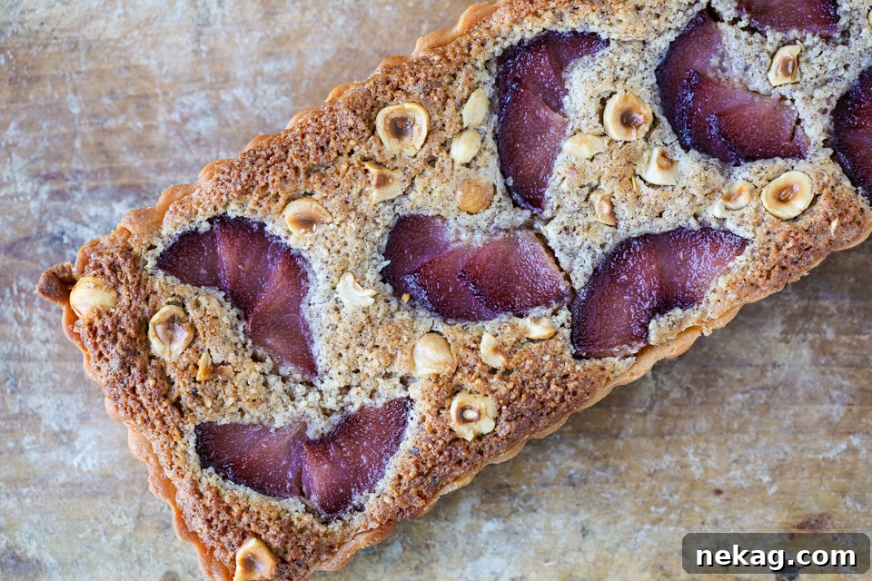 A whole Hazelnut Pear Tart baked in a rectangular pan, showing the artful arrangement of pears.