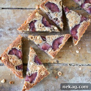 Hazelnut Pear Tart Sliced on wooden board